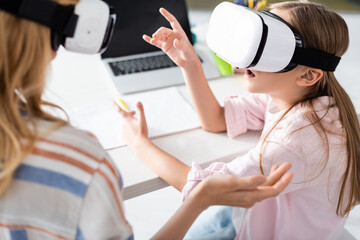 Wall Mural - Selective focus of mother and excited kid using vr headsets at home