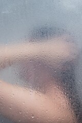 Sticker - Female figure in a shower cabin behind wet glass