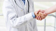 © Яна Солодкая - Doctor shakes hands with a patient isolated on white background