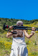 © JuanFrancisco - girl with a professional tripod of photography and video walks on the mountain in summer