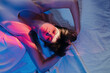 © Sergey Filimonov/Stocksy - Woman with short hair lying on bed