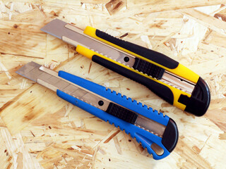 Two cutters on a wooden background, knives