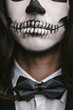 © Mosuno/Stocksy - portrait of young man with skull Halloween facepaint
