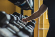 © Javier Pardina/Stocksy - Strong and healthy man catching a dumbbell inside a crosffit gym