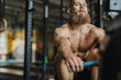 © Javier Pardina/Stocksy - Strong and healthy man working out on a rowing machine, inside a crossfit gym.