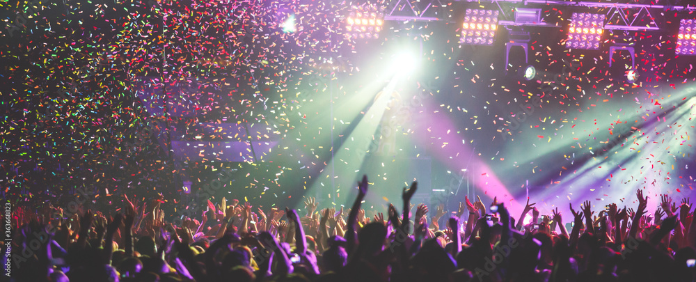 Concert hall with stage lights and large audience representing Drake's massive live performance success and touring revenue