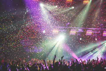 Wall Mural - A crowded concert hall with scene stage lights, rock show performance, with people silhouettes during live music show performance with crowd of audience