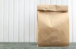 © BillionPhotos.com - Brown paper bag on wooden interior background