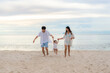 © Prasit Rodphan - Happy Asian family holidays during joyful father, mother and daughter running together along summer sunset sea. Happy family travel on beach in holiday, Summer and vacation.