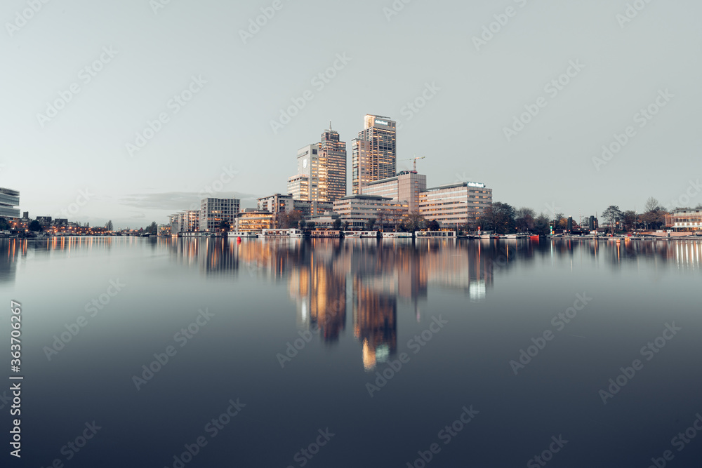 Reflection Of Buildings In River Against Clear Sky - obrazy, fototapety, plakaty 