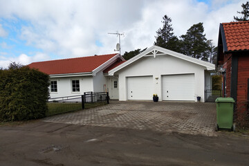 Wall Mural - White new garage for two cars and wooden barn on private house yard.