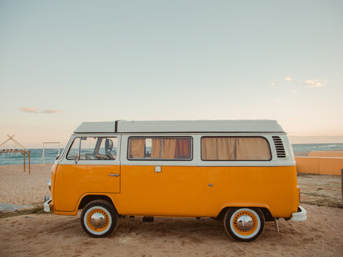 vintage van at beach against sky during sunset