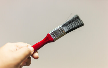 hand holding paintbrush