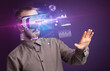 © ra2 studio - Businessman looking through Virtual Reality glasses with BUDGET inscription, new business concept