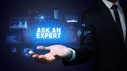 Hand of Businessman holding ASK AN EXPERT inscription, business success concept