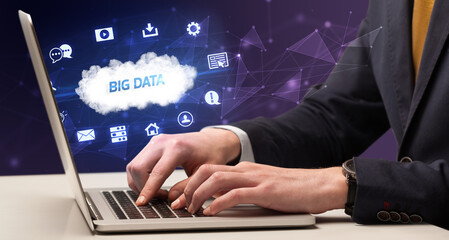 businessman working on laptop with big data inscription, modern technology concept
