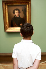 Child looking at famous portrait of Pushkin