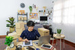 © Pichsakul - Asian man business owner working with laptop for checking packaging delivery e-commerce online market on purchase orders to customer