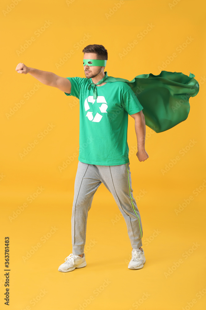 Man dressed as eco superhero on color background