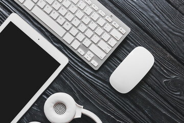 PC keyboard, tablet, mouse and headphones on table