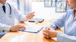 © Pichsakul - Charming Asian male doctor giving advice and medical informations and diagnosis to a female patient at consulting room in clinic.