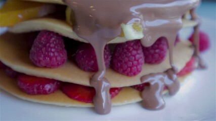 Poster - Stack of pancakes with strawberry, raspberry and Orange with chocolate sauce