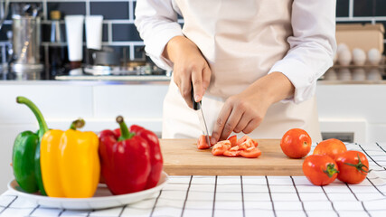 Wall Mural - Asian woman is preparing healthy food vegetable salad at light kitchen Cooking At Home and healthy food concept
