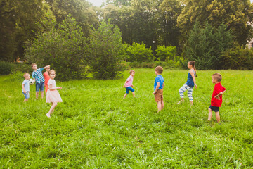 Wall Mural - The children have fun and play sports with a ball