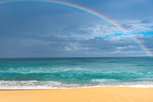 Scenic View Of Sea Against Rainbow In Sky