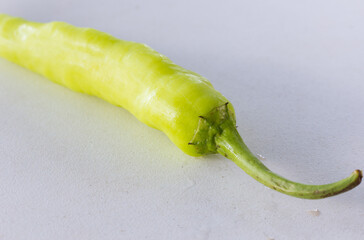 Wall Mural - Green pepper on white table