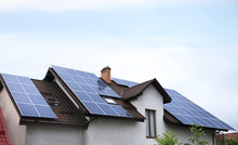 House With Installed Solar Panels On Roof. Alternative Energy Source