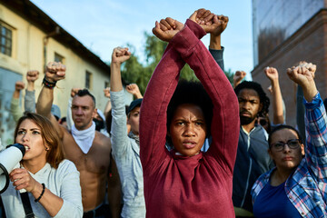 Wall Mural - African American woman with arm-crossing gesture on public demonstrations.