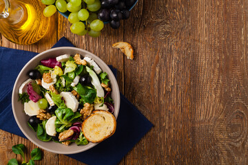 Wall Mural - Italian spring salad with goat cheese, grapes and walnuts. Served with croutons.