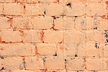 Brick Wall Is Painted With Orange Paint. Abstract Architectural Background.