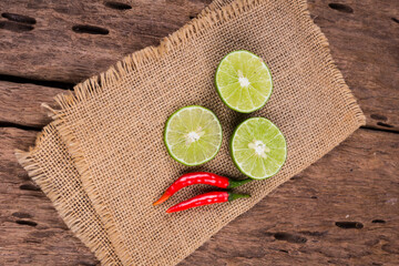 Wall Mural - Fresh lemon and fresh red peppers on the old wooden floor.