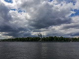 Fototapeta Tęcza - panoramic view of Smolny Cathedral in Saint Petersburg across the Neva river against a dramatic cloudy sky
