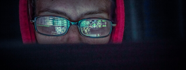 Wall Mural - hacker at computer data reflecting in eyeglasses