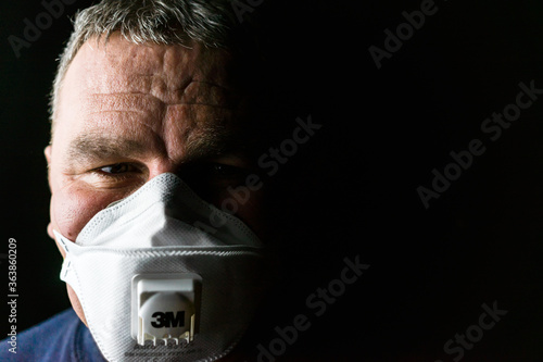 Portrait Of Man Wearing Face Mask Against Black Background