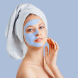 © Olesia - Cosmetology, skin care, face treatment, spa and natural beauty concept. Woman with facial mask.