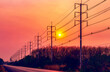 © NtDanai - Silhouette of electric pole with cable on dramatic sunset sky along the road