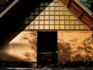 Canvas Print - Sunny scenery of a small house with thatch walls