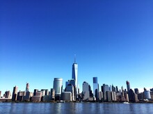 River By One World Trade Center Against Clear Blue Sky