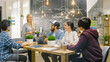 © Gorodenkoff - Female Team Leader Speaking at the Group Meeting, Discussing Company's Aims, Ambitions and Future Projects. Creative Young  Developers in the Trendy Office Environment.