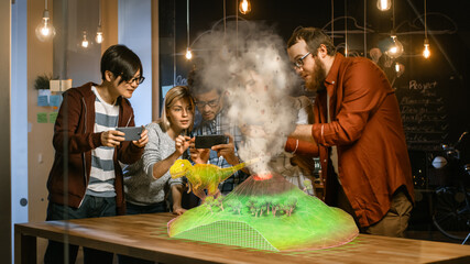 Wall Mural - group of young developers look at dinosaur and volcano eruption in augmented reality through smartph