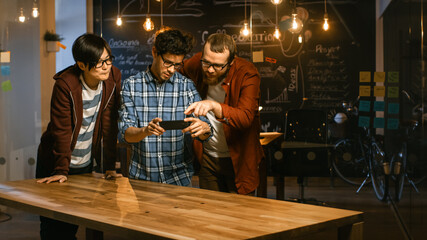 Wall Mural - great concept for augmented reality mock-up. three young developers look at augmented reality throug