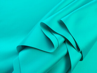 Wall Mural - Beautiful elegant wavy turquoise silk or satin luxury cloth fabric texture, abstract background design.