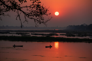 Wall Mural - A colorful dawn over the river Narmada with sunrise at Cheepaner Ghat, Madhya Pradesh, India.