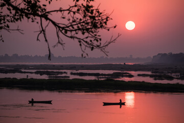 Wall Mural - A colorful dawn over the river Narmada with sunrise at Cheepaner Ghat, Madhya Pradesh, India.