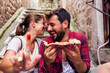 © Novak - Cute young couple eating pizza outdoor