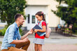 © Angelov - first day at school. father leads a little child school girl in first grade